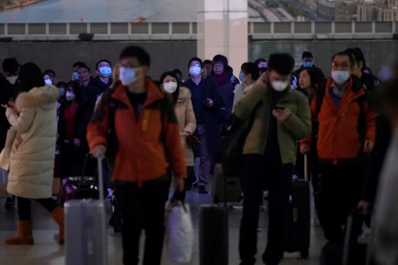 Passengers wearing masks are seen at Shanghai railway station in Shanghai