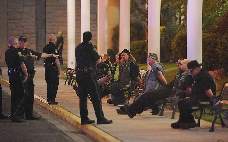 FILE - In this Sept. 23, 2011, file photo, police officers keep an eye on handcuffed men at the east entrance to John Ascuaga's Nugget hotel-casino after a shooting in Sparks, Nev. Eight accused Vagos biker gang members were acquitted Monday, Feb. 24, 2020, of all charges including allegations they were part of a broad criminal racketeering enterprise that committed violent crimes including the killing of a rival Hells Angels leader in a northern Nevada casino shootout in 2011. (The Reno Gazette-Journal via AP, File)