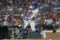 New York Mets' Jeff McNeil hits a single against the Atlanta Braves during the first inning of a baseball game Saturday, Oct. 1, 2022, in Atlanta. (AP Photo/Brett Davis)