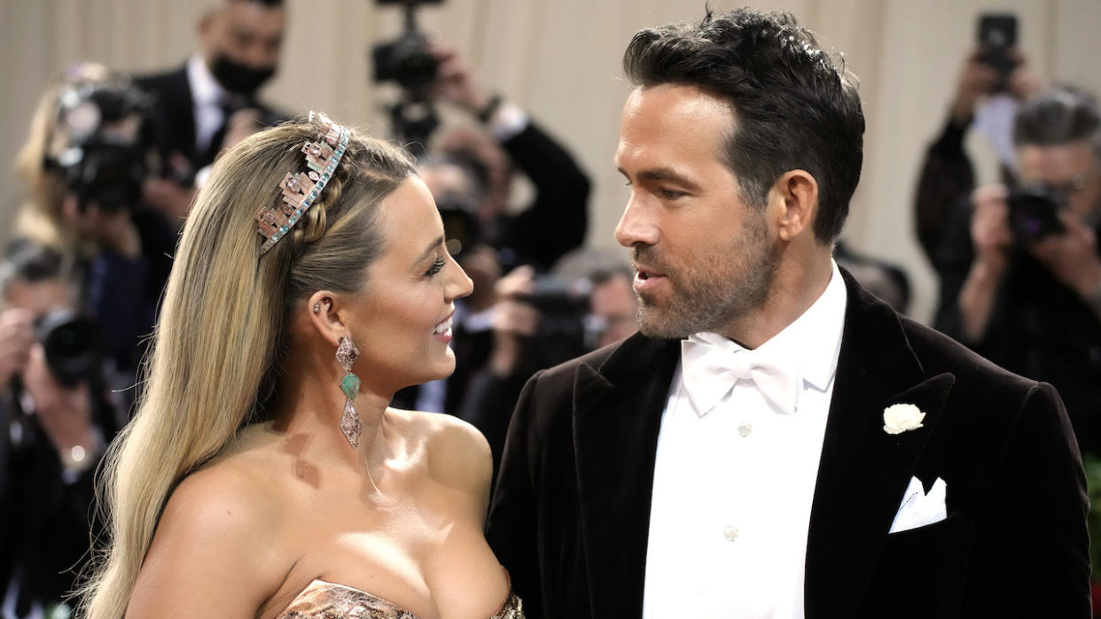  Reynolds and Lively smiling at each other at the Met Gala. 