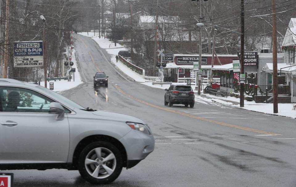 A car on Akron-Peninsula road crosses Ohio State Route 303 in the heart of Peninsula. Institute for Justice, a national nonprofit law firm, is urging Peninsula to make it free to contest traffic camera tickets.