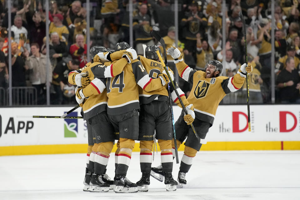 Vegas Golden Knights players celebrate a goal against the Florida Panthers during the third period of Game 1 of the NHL hockey Stanley Cup Finals, Saturday, June 3, 2023, in Las Vegas. (AP Photo/John Locher)