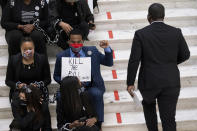 Protesters opposed to changes in Georgia's voting laws sit on the steps inside the State Capitol in Atlanta, Ga., as the Legislature meets Monday, March 8, 2021, in Atlanta. (AP Photo/Ben Gray)