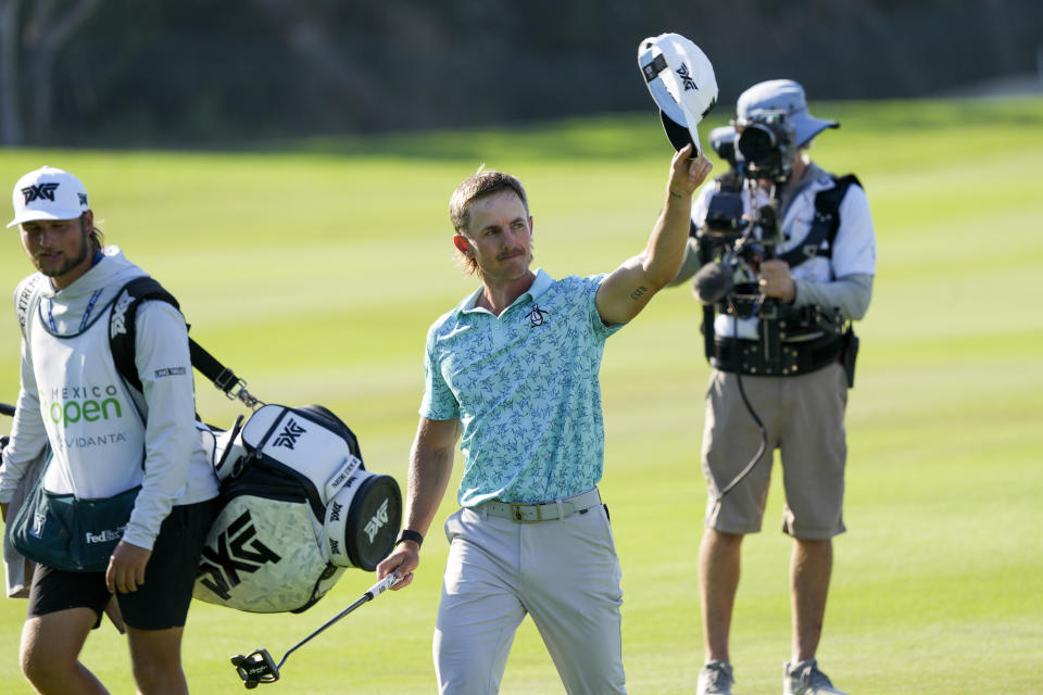 Jake Knapp, of the United States, greets fans as he arrives to 18th hole during the final round of the Mexico Open golf tournament in Puerto Vallarta, Mexico, Sunday, Feb. 25, 2024. (AP Photo/Fernando Llano)