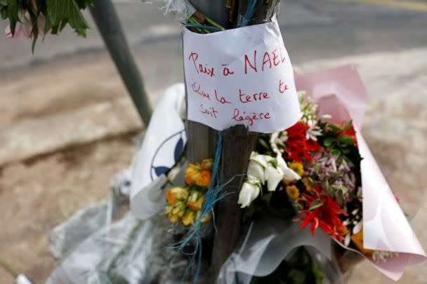 PHOTO: Flowers are seen at the site where 17-year-old Nahel M. was shot and killed by a police officer in Nanterre, a suburb of Paris, France, on June 29, 2023. The message reads 'Peace to Nael, may the earth be light to you.' (Gonzalo Fuentes/Reuters)