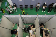 People receive the first dose of the Pfizer-BioNTech COVID-19 coronavirus vaccine at a vaccination center in Seoul, Wednesday, July 28, 2021. South Korea reported a new daily high for coronavirus cases, a day after authorities enforced stringent restrictions in areas outside the capital region. (AP Photo/Ahn Young-joon)