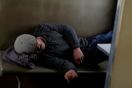 A man sleeps on the train from Hotan to Kashgar, Xinjiang Uighur Autonomous Region, China, March 22, 2017. REUTERS/Thomas Peter