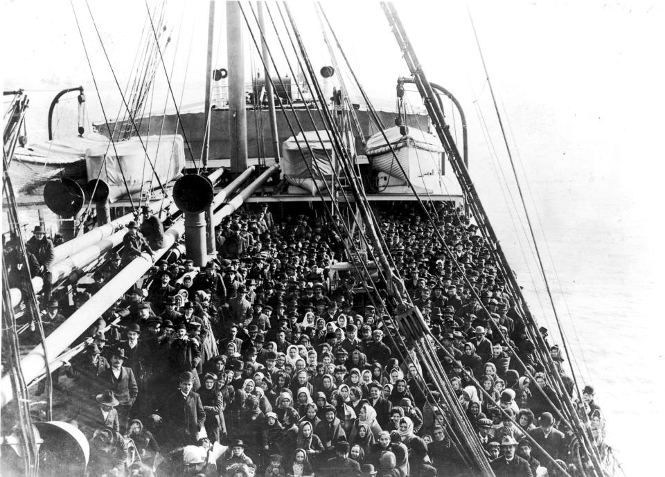 <p>Immigrants pack the upper deck of the liner SS Patricia as it travels from Hamburg, Germany, to New York, Dec. 10, 1906. (Photo: Edwin Levick/FPG/Getty Images) </p>