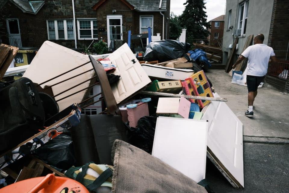 Residents sort through belongings from their flooded home in a Queens neighborhood that saw massive flooding and numerous deaths following a night of heavy wind and rain from the remnants of Hurricane Ida on September 3, 2021 in New York City (Getty Images)