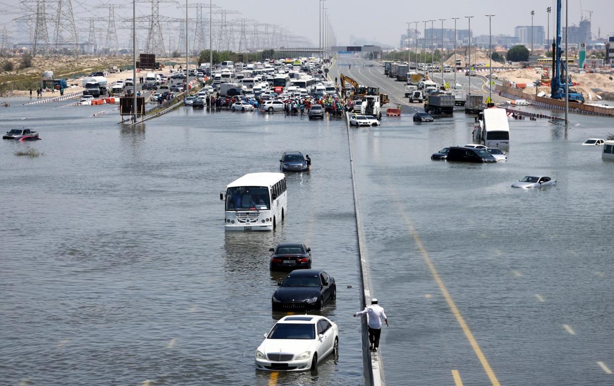 Abandoned vehicles on a flooded highway in Dubai, United Arab Emirates