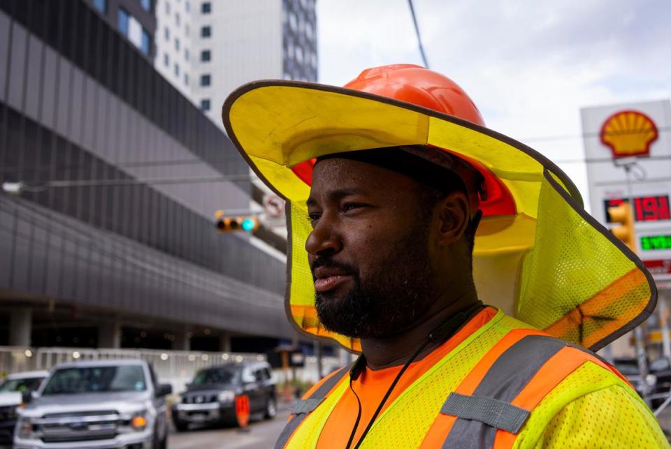 Marque Clark, 41, of Austin, a traffic control employee, works through the late morning heat in Austin’s West Campus neighborhood on July 6, 2023.