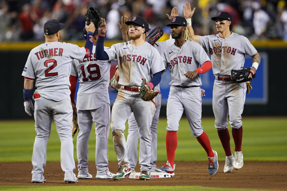 Boston Red Sox players celebrate after a baseball game against the Arizona Diamondbacks, Saturday, May 27, 2023, in Phoenix. The Red Sox defeated the Diamondbacks 2-1. (AP Photo/Matt York)