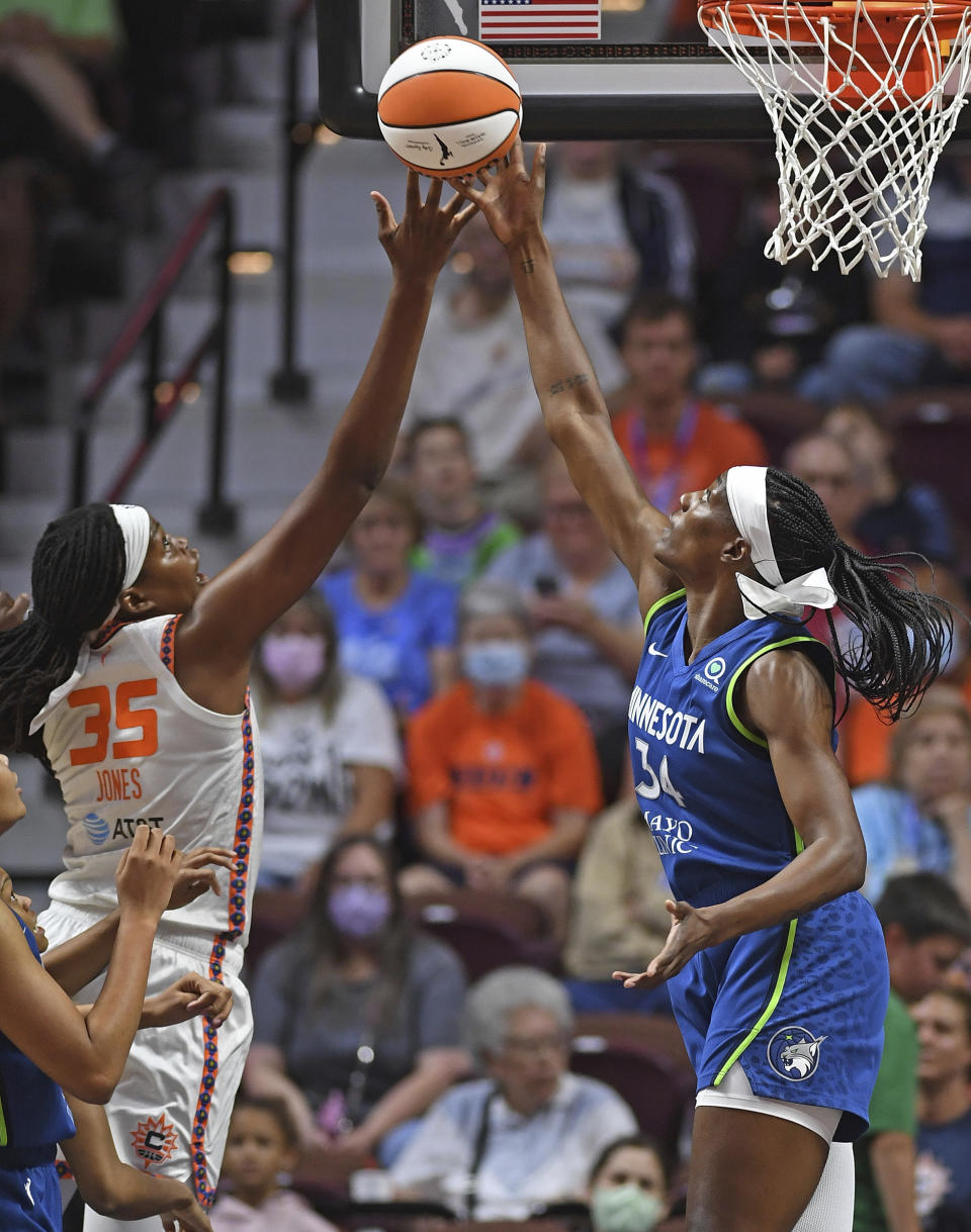 Minnesota Lynx center Sylvia Fowles (34) battles against Connecticut Sun forward Jonquel Jones (35) for a rebound during a WNBA basketball game Sunday, Aug. 14, 2022, in Uncasville, Conn. (Sean D. Elliot/The Day via AP)