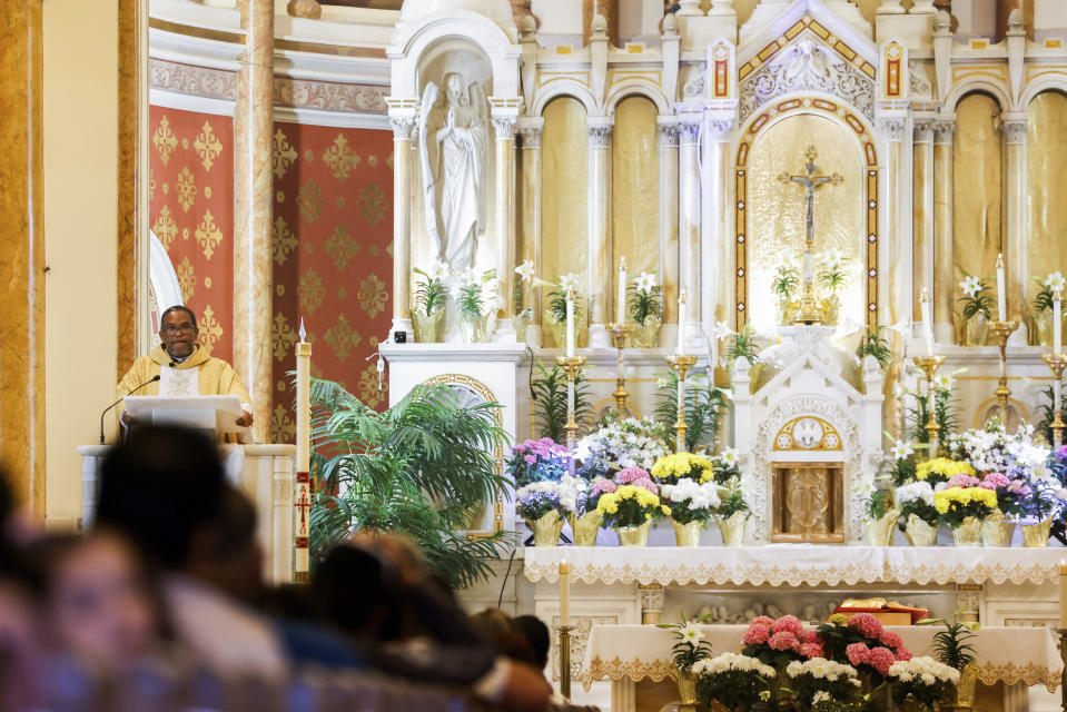 Father Ako Walker leads Easter Mass at Sacred Heart of Jesus and Saint Patrick, Sunday, March 31, 2024, in Baltimore, Md. (AP Photo/Julia Nikhinson)