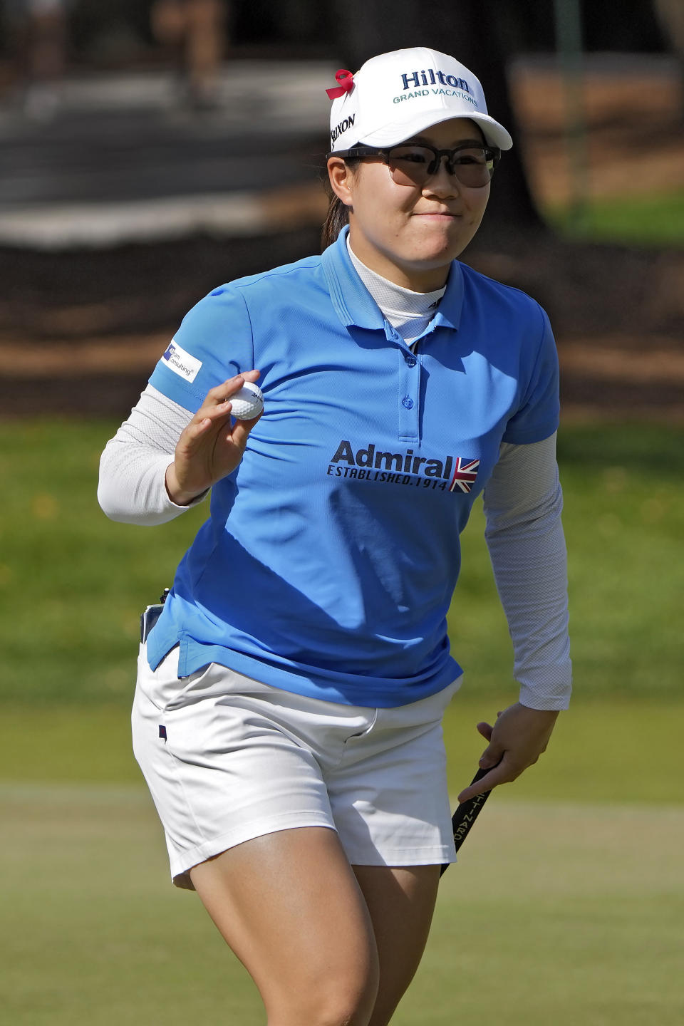 Nasa Hataoka, of Japan, holds up her golf ball after making a birdie putt on the 10th hole during the first round of the Hilton Grand Vacations Tournament of Champions LPGA golf tournament Thursday, Jan. 19, 2023, in Orlando, Fla. (AP Photo/John Raoux)