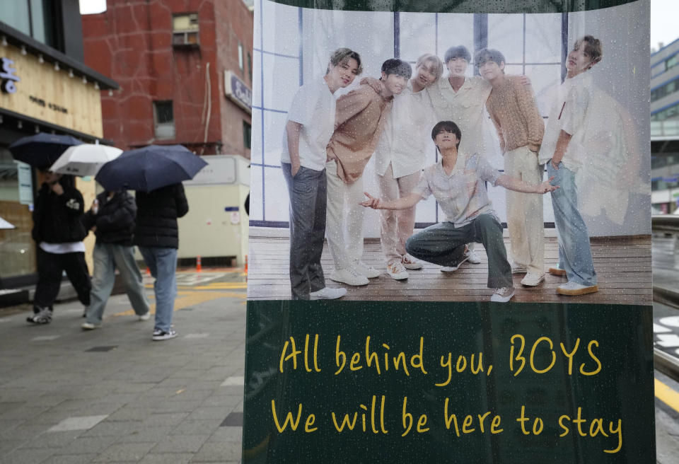 A banner showing members of South Korean K-pop band BTS is displayed on a street in Seoul, South Korea, Monday, Dec. 11, 2023. Singers RM and V of the K-pop band BTS began their mandatory military duties under South Korean law, their management agency announced Monday. This came a day before two of their bandmates, Jimin and Jung Kook, were also expected to report for duty. (AP Photo/Ahn Young-joon)