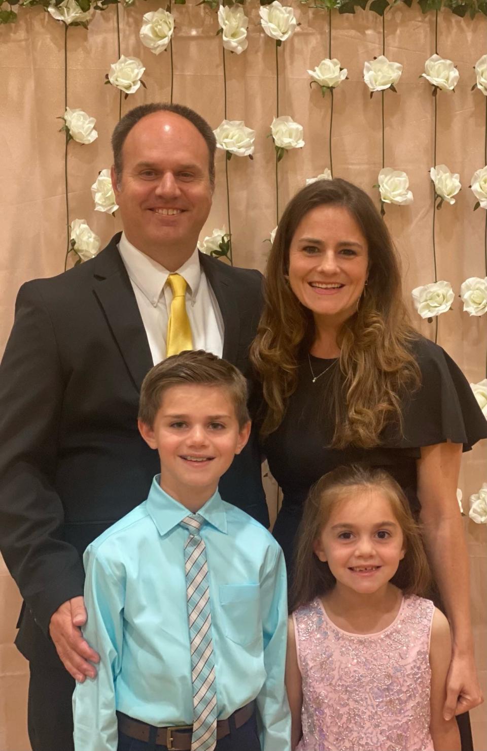 Michael Walta, left on second row, was named band director for Wichita Falls Memorial High School. He is shown here with his family, wife Janelle, son Aiden and daughter Kinsley.