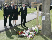 <p>U.S. President George W. Bush and Gov. Tim Kaine are joined by their wives as they look at a memorial in honor of the 32 people killed Monday by a gunman at Virginia Tech in Blacksburg, Va., April 17, 2007. (Photo: Larry Downing/Reuters)</p>