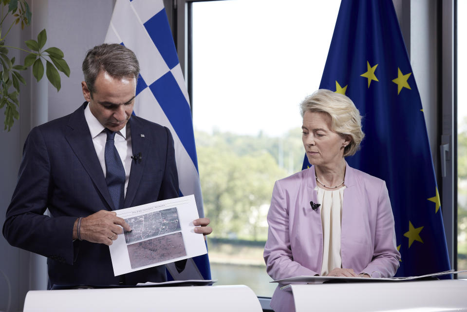 In this photo provided by the Greek Prime Minister's Office, Greece's Prime Minister Kyriakos Mitsotakis, left, and EU Commission President Ursula von der make statements after their meeting in Strasbourg, France, Tuesday, Sept. 12, 2023. The European Union is promising Greece more than 2 billion euros ($2.15 billion) in financial support in the wake of massive summer wildfires and ongoing floods that have caused extensive damage across central Greece. (Dimitris Papamitsos/Greek Prime Minister's Office via AP)