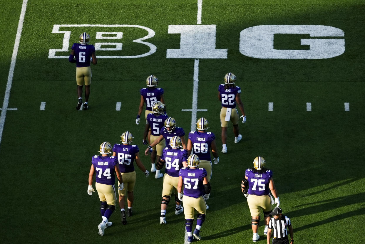 Washington players walk to the sideline during a timeout against Northwestern during the first half of an NCAA college football game Saturday, Sept. 21, 2024, in Seattle. (AP Photo/Lindsey Wasson)