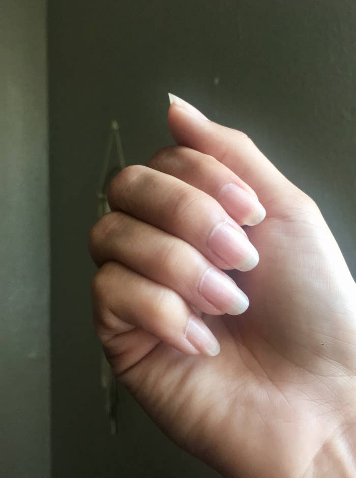 close up image of long natural nails with clear polish