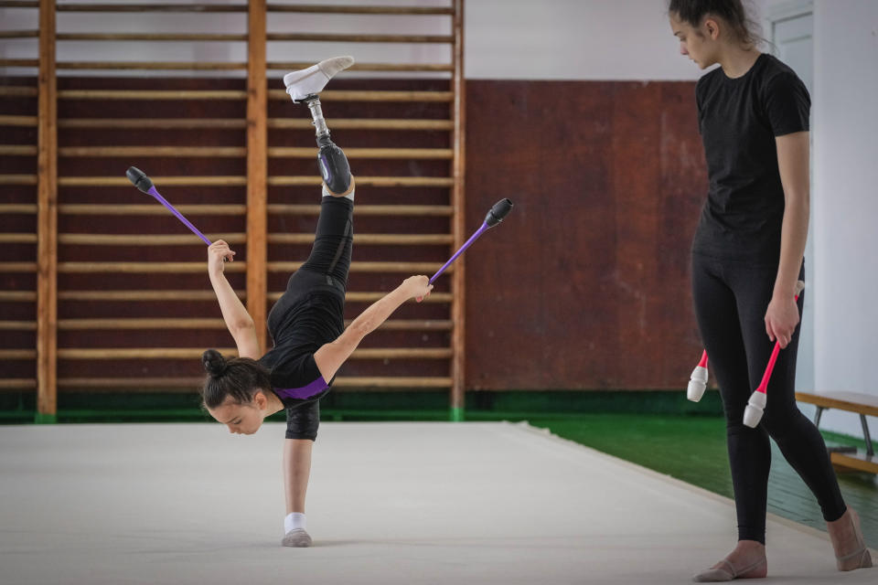 Oleksandra Paskal, an 8-year-old girl with a prosthetic leg, practices rhythmic gymnastics with other girls in Chornomorsk, Odesa region, Ukraine, Thursday, May 16, 2024. (AP Photo/Efrem Lukatsky)