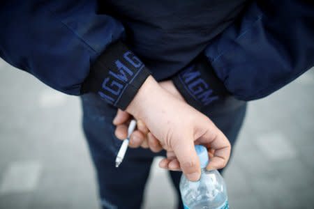 Shin Hyun-chang, who used to work at an engine line in GM Korea's Bupyeong plant, smokes a cigarette outside the plant in Incheon, South Korea March 12, 2018. Picture taken March 12, 2018. REUTERS/Kim Hong-Ji