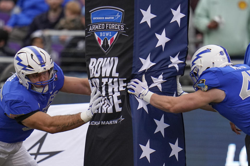 Air Force defensive end Daniel Grobe, left, and offensive lineman Luke Meyer warm up prior to the Armed Forces Bowl NCAA college football game against James Madison, Saturday, Dec. 23, 2023, in Fort Worth, Texas. (AP Photo/Julio Cortez)