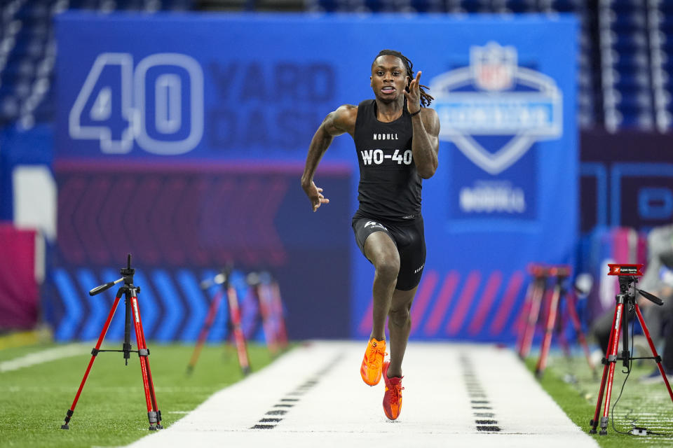 Texas wide receiver Xavier Worthy runs the 40-yard dash at the NFL football scouting combine, Saturday, March 2, 2024, in Indianapolis. (AP Photo/Michael Conroy)