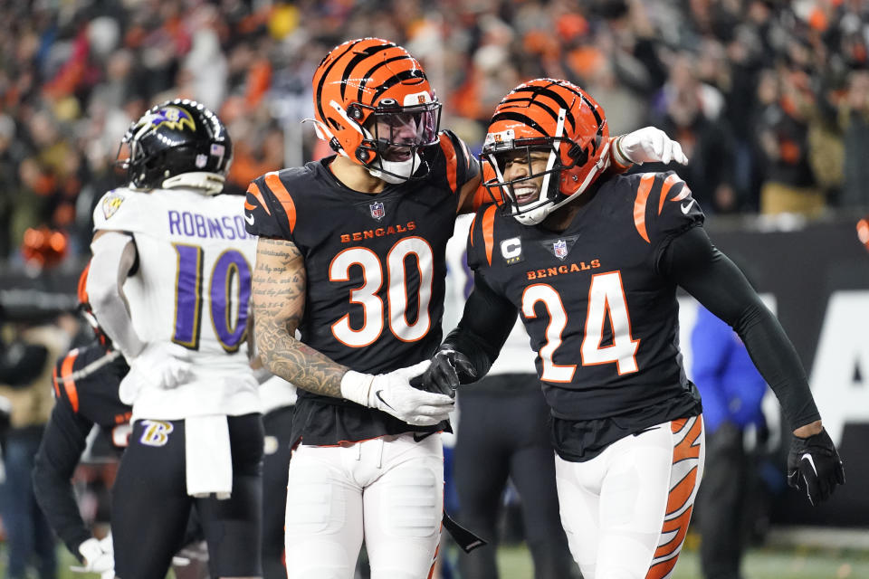 Cincinnati Bengals safety Vonn Bell (24) and safety Jessie Bates III (30) celebrate as Baltimore Ravens wide receiver Demarcus Robinson (10) is seen in the background following an NFL wild-card playoff football game in Cincinnati, Sunday, Jan. 15, 2023. The Bengals won 24-17. (AP Photo/Joshua A. Bickel)