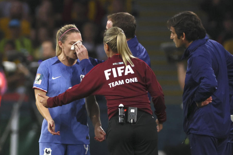 France's Eugenie Le Sommer receives medical attention during the Women's World Cup quarterfinal soccer match between Australia and France in Brisbane, Australia, Saturday, Aug. 12, 2023. (AP Photo/Tertius Pickard)