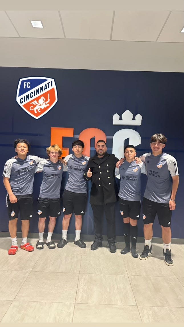 (From left to right) Angelo Vieyra, Caleb Cliburn, Daniel Guerra, Chris Hernandez, Angelnoe Perez and Aaron Chavez pose for a photo in front of the F.C Cincinnati logo during their youth club trials in Cincinnati, Ohio.