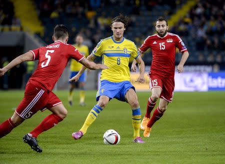 Sweden's Albin Ekdal (C) controls the ball against Liechtenstein's Ivan Quintans (L) and Seyhan Yildiz during their Euro 2016 qualifying soccer match in Stockholm on October 12, 2014. REUTERS/Janerik Henriksson/TT News Agency