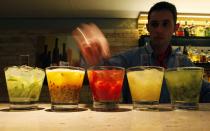 A barman prepares "Caipirinhas", Brazil's national cocktail, made with cachaca (sugar cane hard liquor), sugar and lemon or another fruit, at Fogo de Chao, a Brazilian steakhouse where food is prepared the traditional gaucho way, in Sao Paulo April 15, 2014. Sao Paulo is one of the host cities for the 2014 World Cup in Brazil. REUTERS/Paulo Whitaker (BRAZIL - Tags: SPORT SOCCER WORLD CUP TRAVEL FOOD SOCIETY TPX IMAGES OF THE DAY)