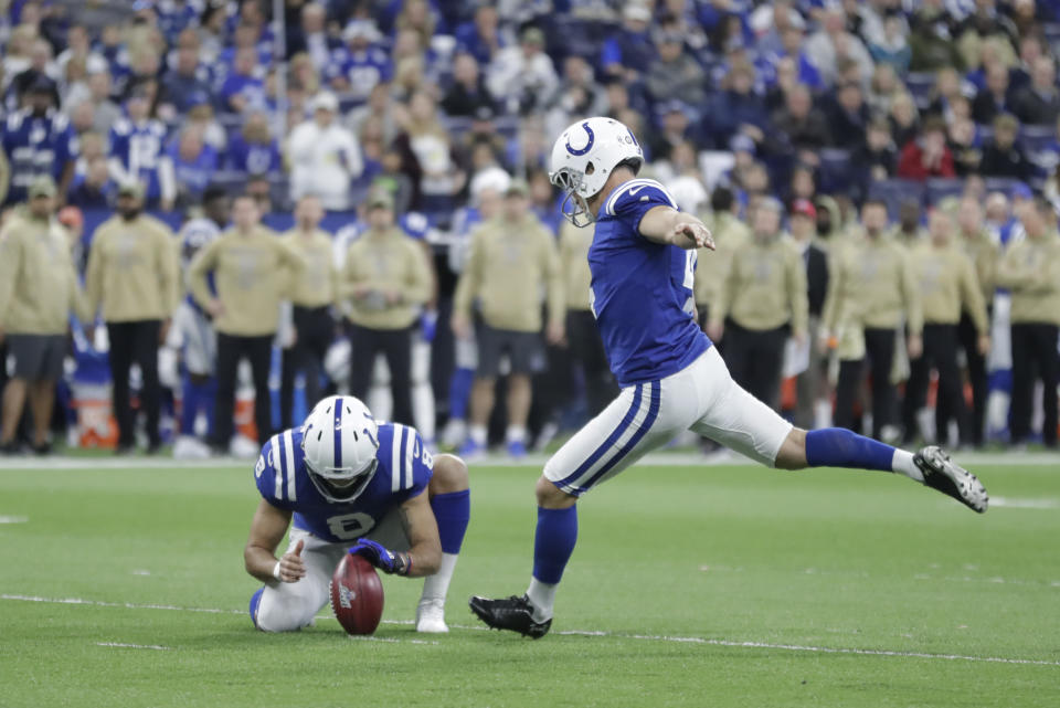 Indianapolis Colts kicker Adam Vinatieri (4) boots a 34-yard field goal out of the hold of Rigoberto Sanchez (8) during the first half of an NFL football game against the Jacksonville Jaguars, Sunday, Nov. 17, 2019, in Indianapolis. (AP Photo/Michael Conroy)