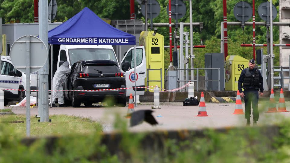 A forensics team inspects the site of a prison convoy ambush in France on Tuesday in which two guards were killed. - Alain Jocard/AFP/Getty Images