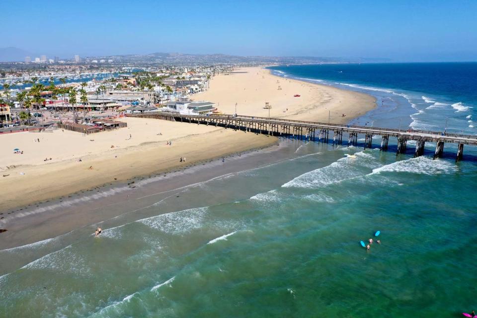 An aerial view of a few surfers and beach-goers enjoying a nice day at the beach despite Gov. Gavin Newsoms hard closure, which is still in place in Newport Beach, CA, on May 4, 2020.