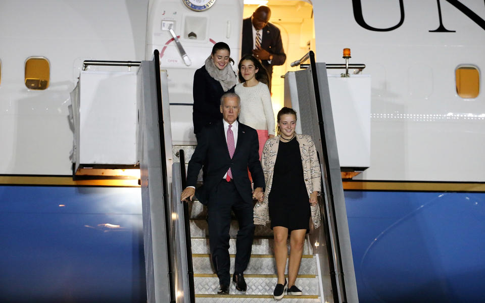 <p>Biden exits an airplane with his granddaughters.</p>