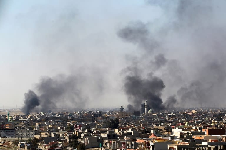 Smoke billows from the Al-Amil neighborhood of west Mosul as Iraqi forces pound Islamic State group positions on March 10, 2017, in fighting that has prompted more and more civilians to flee