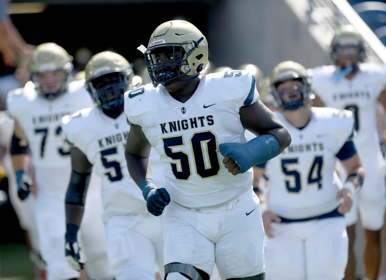 Hoban Knights, including William Satterwhite, take the field against Frederick Douglass at Tom Benson Hall of Fame Stadium on Aug. 19