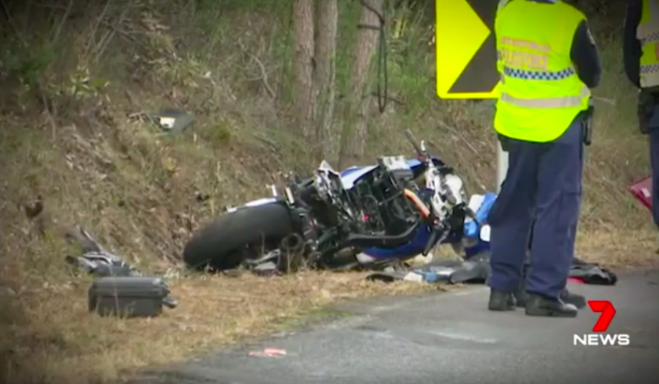 A severely damaged motorbike lies on the ground at the crash site. Source: 7News