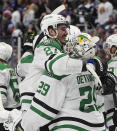 Dallas Stars left wing Mason Marchment, left, hugs goaltender Jake Oettinger after Game 6 of an NHL hockey playoff series Friday, May 17, 2024, in Denver. (AP Photo/David Zalubowski)