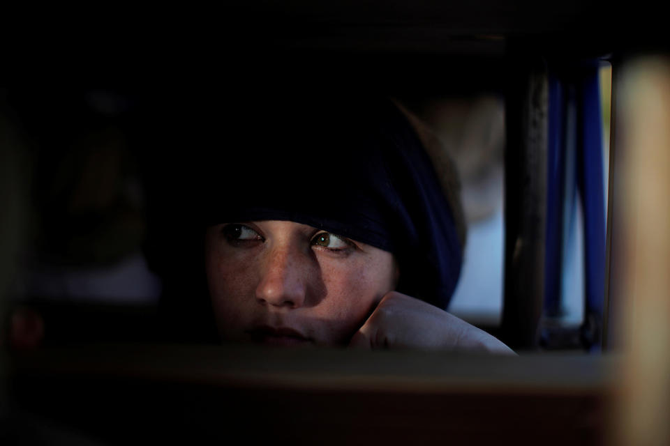 A costalera takes a rest as she carries a weighted float in Ronda