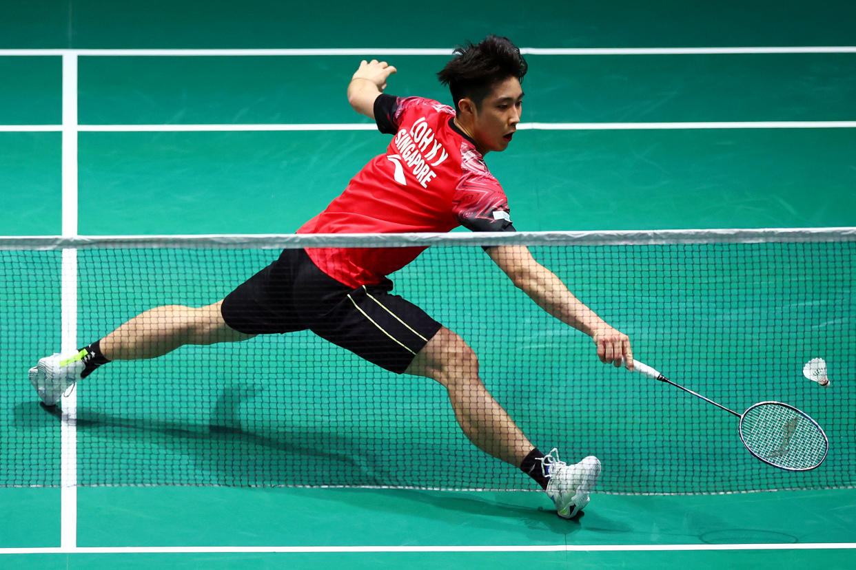 Singapore shuttler Loh Kean Yew stretches to return against Indonesia's Anthony Sinisuka Ginting in their men's singles semi-final match during at the Singapore Badminton Open. 