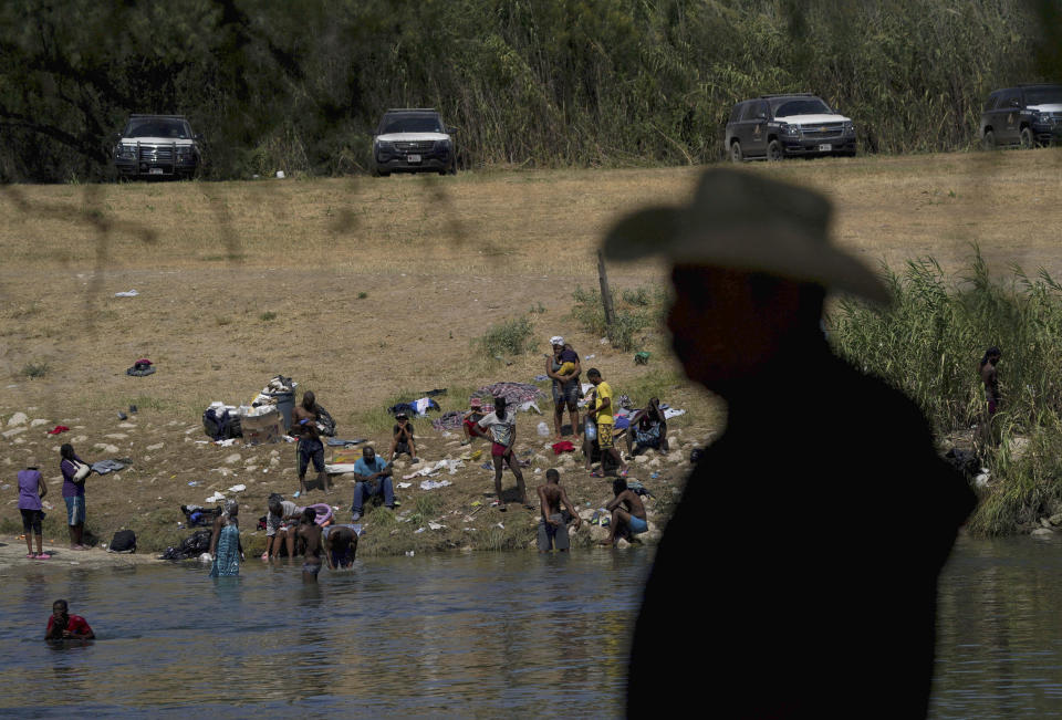 FILE - In this Sept. 22, 2021, file photo migrants, many from Haiti, wade across the Rio Grande from Del Rio, Texas, to return to Ciudad Acuna, some to avoid possible deportation from the U.S. and others to get supplies. In the past week, the push to change the nation's immigration laws and create a path to citizenship for young immigrants brought illegally to the country as children faced a serious setback on Capitol Hill. Bipartisan negotiations to overhaul policing collapsed and searing images of Haitian refugees being mistreated at the U.S.-Mexico border undermined President Joe Biden's pledge of humane treatment for those seeking to enter the United States. (AP Photo/Fernando Llano, File)