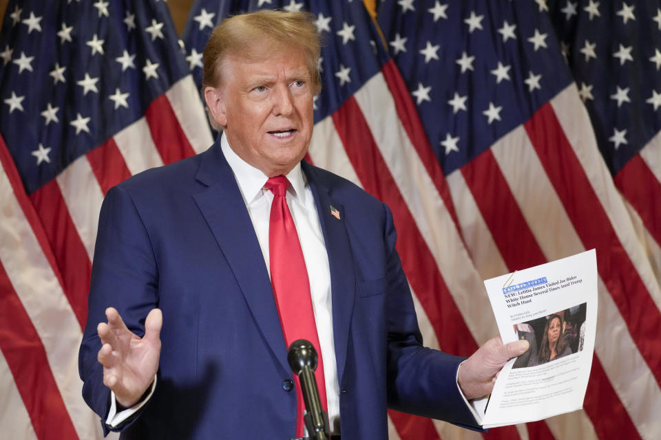 Former President Donald Trump holds up a copy of a story featuring New York Attorney General Letitia James while speaking during a news conference, Thursday, Jan. 11, 2024, in New York. Trump's lawyers presented closing arguments in his civil business fraud trial earlier in the day. (AP Photo/Mary Altaffer)