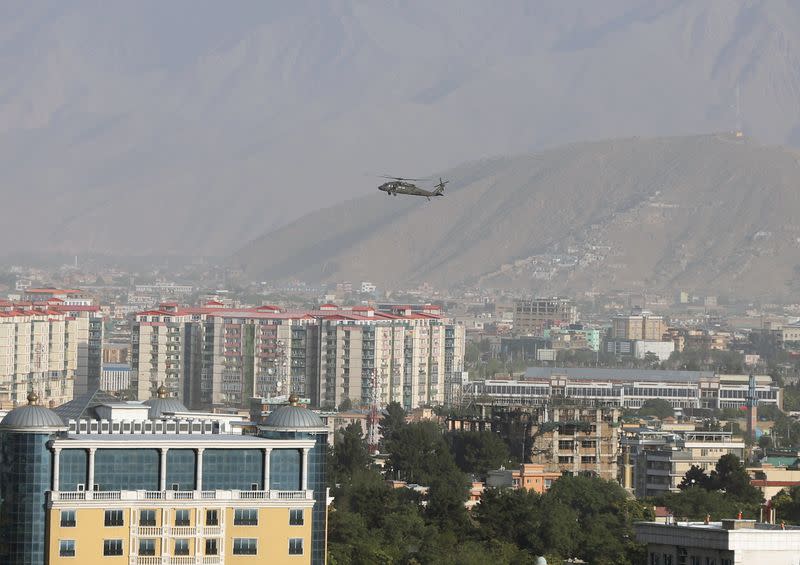 FILE PHOTO: A NATO helicopter flies over the city of Kabul, Afghanistan