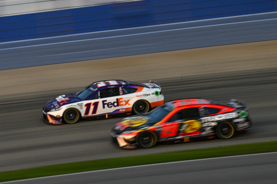 LEBANON, TENNESSEE - JUNE 25: Denny Hamlin, driver of the #11 FedEx Ground Toyota, and Martin Truex Jr., driver of the #19 Bass Pro Shops Toyota, race during the NASCAR Cup Series Ally 400 at Nashville Superspeedway on June 25, 2023 in Lebanon, Tennessee. (Photo by Logan Riely/Getty Images)