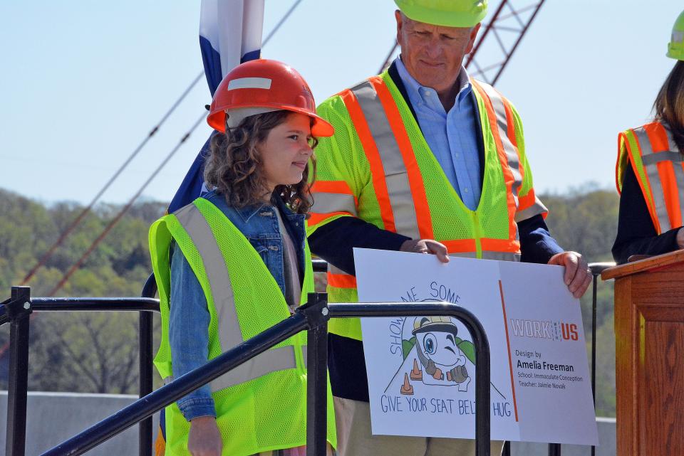 Immaculate Conception Catholic School fifth-grade student Amelia Freeman, left, is recognized Tuesday for her winning work zone safety billboard design during the kickoff of National Work Zone Awareness Weeek from the Lance Cpl. Leon Deraps Missouri River Bridge at Rocheport. 