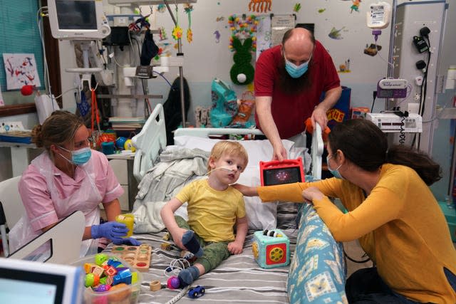 Three-year-old Ethan Mains from Glasgow, with mother Alexa Ispas, right, and father Stuart, a patient on Ward 23 at the Freeman Hospital in High Heaton, Newcastle Upon Tyne, who is in need of a heart donor